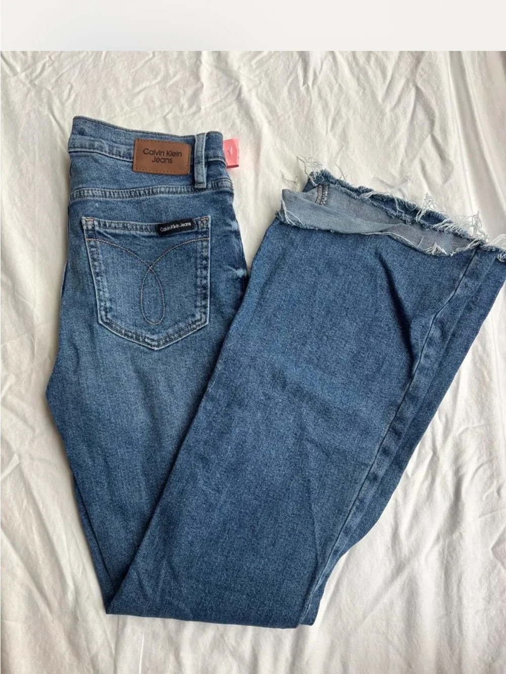 Calvin Klein Medium Wash Flare Leg Jeans with Raw Hem